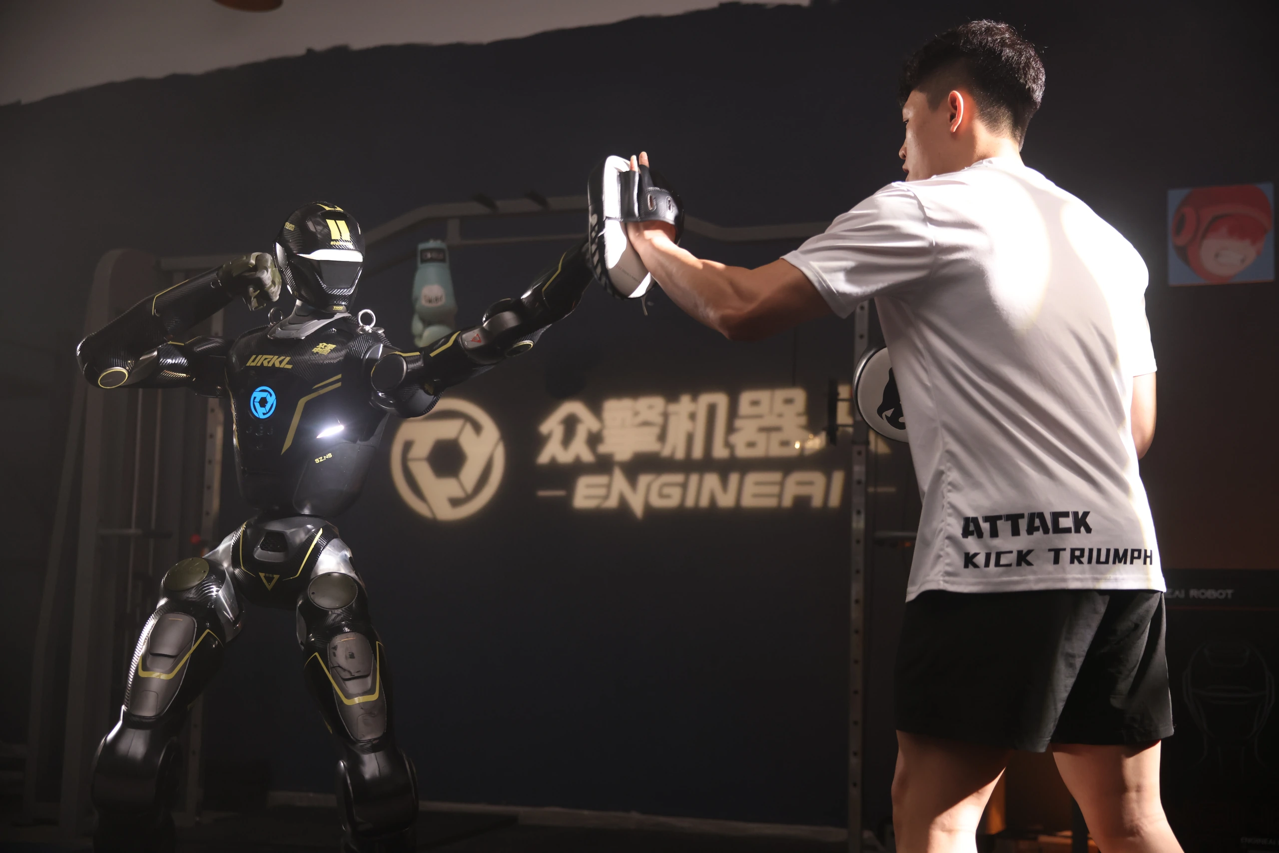 A person standing beside an EngineAI humanoid at an event